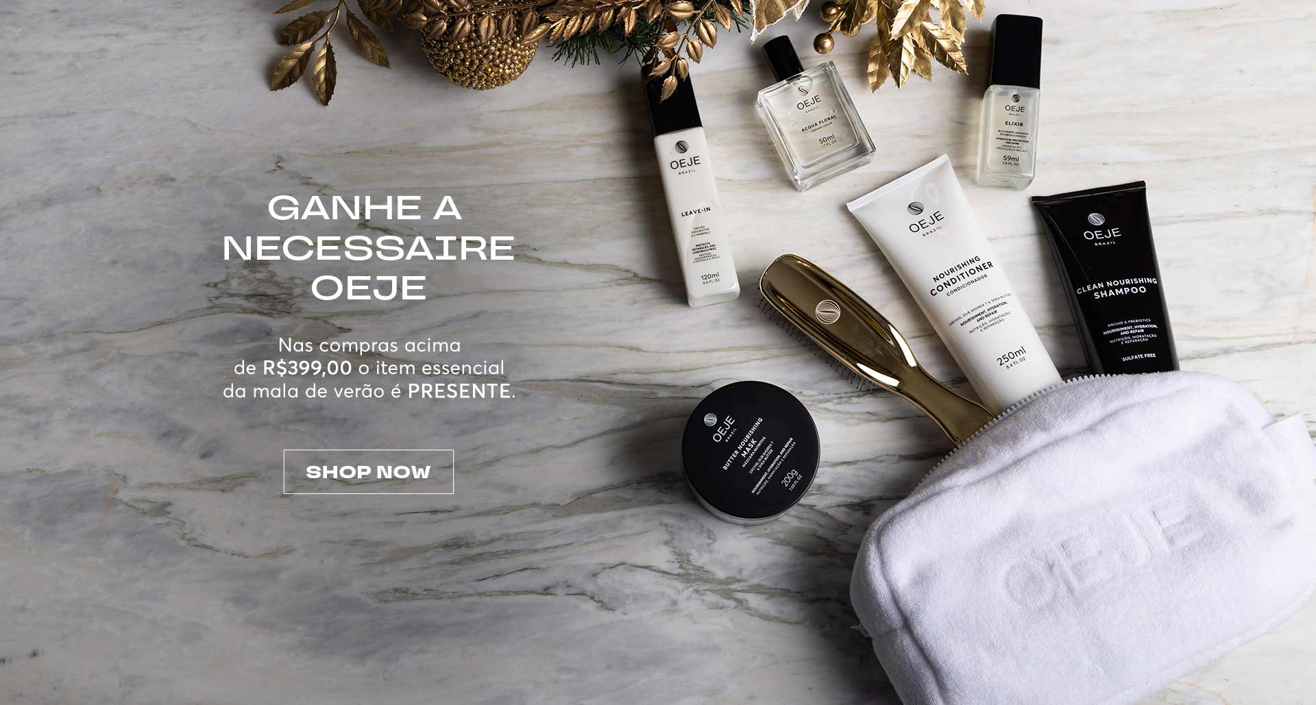 Produtos OEJE (shampoo, condicionador, máscara, leave-in, elixir, perfume) e necessaire branca sobre mármore.