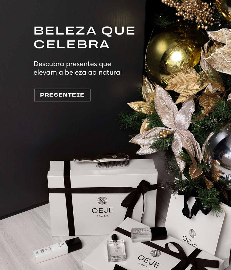 Presentes de beleza OEJE Brazil: caixas e sacolas brancas com laços pretos, produtos e escova, junto a enfeites natalinos dourados.